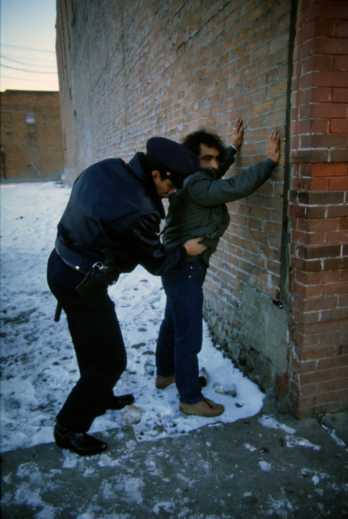 Man receiving a pat down from a Billings police officer, December 1984
